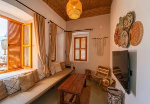 a living room with a couch and a table at Notarius Hotel Bodrum in Bodrum City