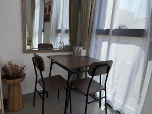 a table and chairs in a room with a mirror at Vacation Like Royalty Every Time in Sharjah +1 photo