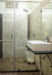 a bathroom with a sink and a glass shower at HOTEL CITY PALACE in Bikaner