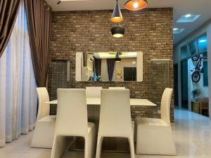 a dining room with a table and chairs and a mirror at Aisy Q Homestay Musliim in Kampong Padang Keladi