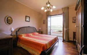 a bedroom with a bed and a large window at Villa Gioiosa in Caramagna Ligure