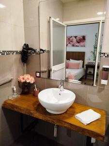 a bathroom with a sink and a mirror at Apartamento Loft Puerto de Gades in Cádiz