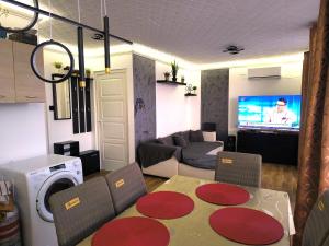 a living room with a couch and a table and a tv at RSD Horgász Szállás in Ráckeve