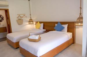 Issara Beach Resort Beachfront客房内的一张或多张床位