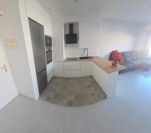 a white kitchen with a sink and a counter top at Costa del Silencio Balcon del mar Summer Tenerife in Arona