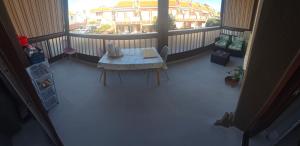 a balcony with a table and a view of a building at Costa del Silencio Balcon del mar Summer Tenerife in Arona