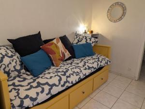 a bed with pillows on it in a room at Chez Marie et Hugo in Brest
