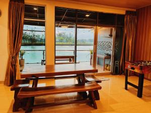 a dining room with a table and a large window at BBQ,Canoe,KTV, Up to 15 Pax, Entire Villa in Batam Center