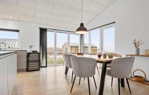 a kitchen and dining room with a table and chairs at 4 Bedroom Stunning Home In Haderslev in Haderslev
