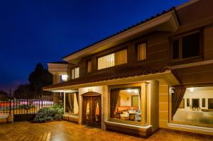 a house at night with the lights on at Hotel Spa CASA REAL in Riobamba