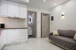a living room with a couch and a kitchen at #Ioanna apartments RooMore 2 in Thessaloniki +7 photos