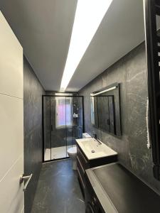 a bathroom with a sink and a toilet and a shower at Apartamento de la playa VUT 7012 AS in San Juan de Nieva +11 photos