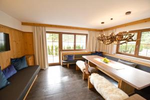 a living room with a table and couches at Superior Chalet Tiroler Madl in Achenkirch