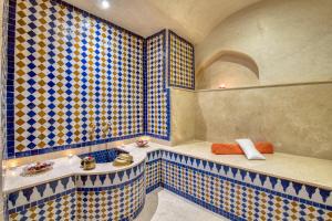a bathroom with blue and yellow tiled walls at Palais Tara & Spa in Marrakesh +77 photos