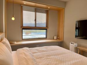 Postel nebo postele na pokoji v ubytování 不想上班 宜蘭民宿-Don't Wanna Work B&B