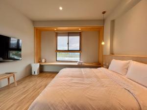 Postel nebo postele na pokoji v ubytování 不想上班 宜蘭民宿-Don't Wanna Work B&B