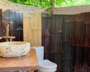 a bathroom with a sink and a toilet on a table at Seed Village in Sekongkang