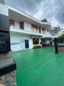 a house with green water in front of it at Bimo Inn Malioboro in Yogyakarta