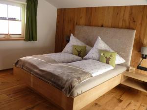 劳里斯Ferienhaus Fahrnberg的卧室内的一张床铺,设有木墙