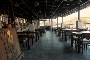 a row of tables and chairs in a restaurant at Castle View Heritage Haveli in Jodhpur