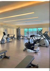 a gym with several cardio bikes and exercise bikes at CoNDOTEL DC in Dumaguete