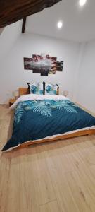 a bedroom with a bed with a blue comforter at Le Coin Zen - Parking, Borne VE et Fibre in Bergheim