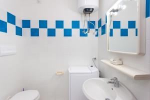 a bathroom with a sink and a toilet and a mirror at Villetta Perla Marina 2 in San Teodoro +19 photos