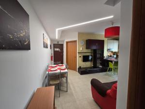 a kitchen and a living room with a table and chairs at Selida Aquamarine House in Vasto