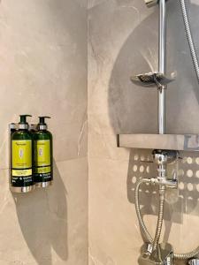 two bottles of disinfectants are sitting on a bathroom sink at Cadee Living - Al Nakheel in Riyadh +140 photos