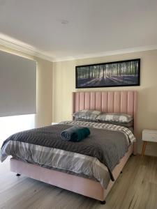 a bedroom with a bed with a bag on it at Ocean breeze villa in Preston Beach