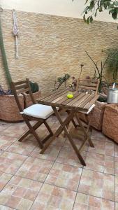 a wooden picnic table and two chairs on a patio at Angú - Casa Vacanze in Avola