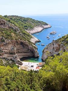 a group of boats in a cove in the ocean at Apartments Hasanovic Rukavac in Podstražje