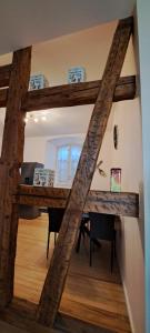 a view of a dining room with a wooden table at L'Arbre Rose - Parking, Borne VE et Fibre in Bergheim