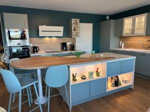 a kitchen with a island with a wooden counter top at A deux pas d'Arras in Saint-Laurent-Blangy