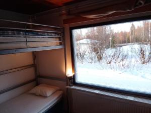 a window in an rv with a view of the snow at Backpackers Hostel Ounasvaara in Rovaniemi