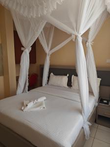Postel nebo postele na pokoji v ubytování Roza Guest House