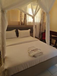 Postel nebo postele na pokoji v ubytování Roza Guest House