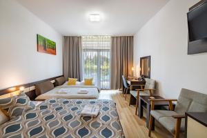 A bed or beds in a room at Bešeňová Apartmán Korzár