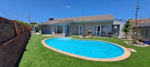 a swimming pool in the yard of a house at Southern Suburbs Stays in Plumstead