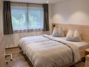 Ένα ή περισσότερα κρεβάτια σε δωμάτιο στο Landresort MUHRHOF