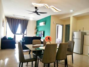 a kitchen and living room with a table and chairs at Elegent Stay Rawang by Bliss Stay Management in Rawang