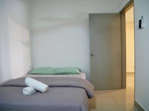 a bedroom with a bed with two towels on it at Elegent Stay Rawang by Bliss Stay Management in Rawang