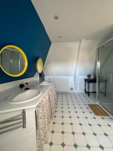 a bathroom with a sink and a mirror at Villa Petit Pierre in Saint-Aubin-sur-Mer +50 photos