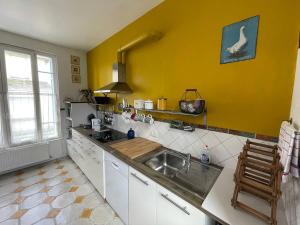 a kitchen with a sink and a counter top at Villa Petit Pierre in Saint-Aubin-sur-Mer