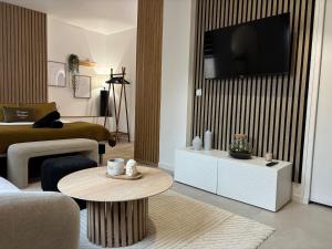 a living room with a couch and a table at Le Lodge in Épernay