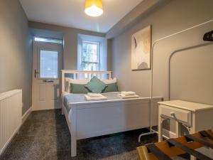 a small bedroom with a white bed and a window at Pass the Keys Happy Haven Home, West End in Glasgow