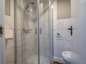 a bathroom with a shower and a toilet at Pass the Keys Happy Haven Home, West End in Glasgow