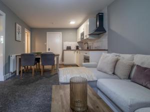 a living room with a couch and a table at Pass the Keys Happy Haven Home, West End in Glasgow