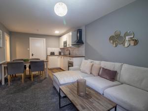 a living room with a couch and a table at Pass the Keys Happy Haven Home, West End in Glasgow +35 photos