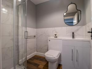 a white bathroom with a toilet and a shower at Pass the Keys Happy Haven Home, West End in Glasgow